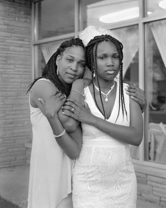 Andrea holding her daughter Nephratiti outside the Social Network Banquet Hall, Flint, Michigan, 2016-2017. From the Series Flint is Family (2016–2022).