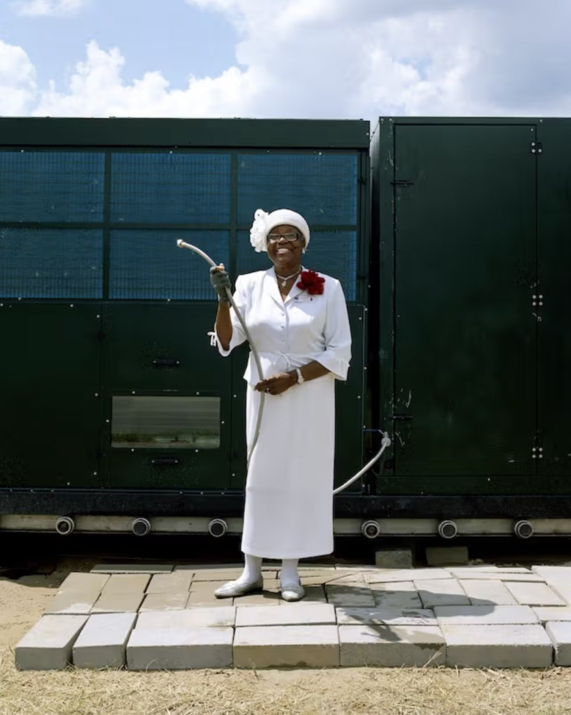 LaToya Ruby Frazier. Mary A. Williams, Tuklor’s Mother, Holding
the Water Hose at the Atmospheric Water Generator on North
Saginaw Street Between East Marengo Avenue and East Pulaski
Avenue, Flint, Michigan from Flint Is Family in Three Acts. 2019–20